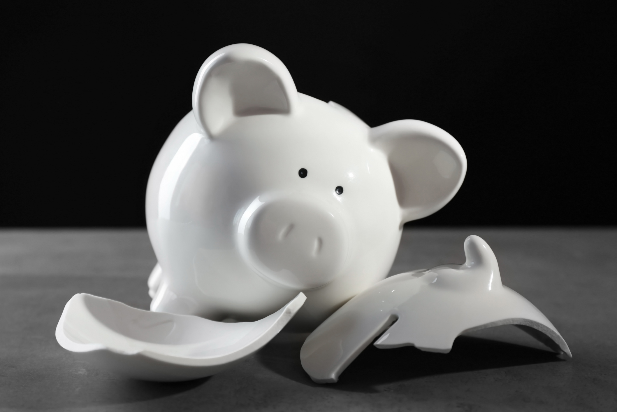 Broken Piggy Bank on Dark Background